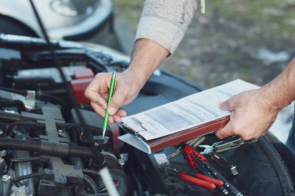 Mechanic repairman checking a car engine.Car service, repair car, repair engine.